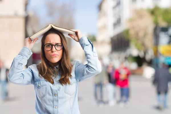 Young girl with book on head — Stock Photo, Image