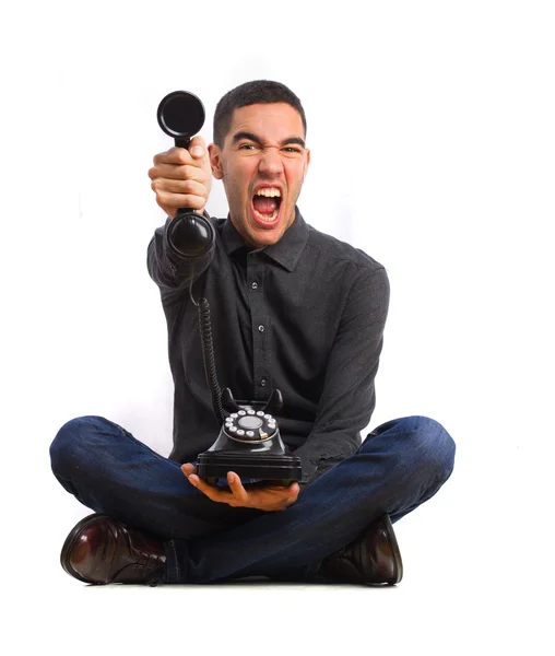 Young man shouting on a telephone — Stock Photo, Image