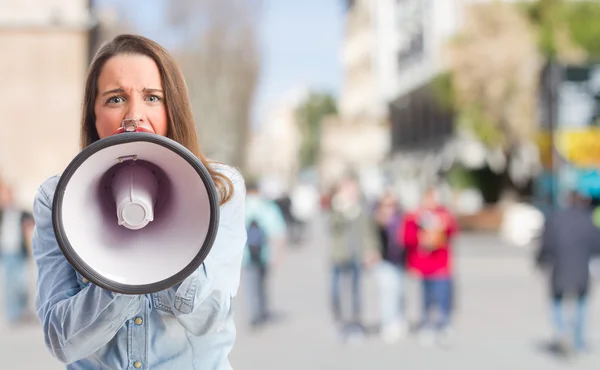 Young girl shouting by megaphone — Stock Photo, Image