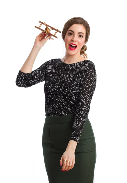 Young girl throwing a wood plane — Stock Photo, Image