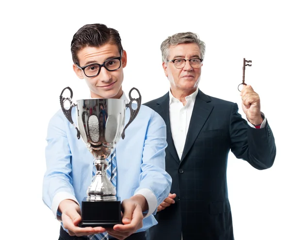 Hombre de negocios con una taza ganadora — Foto de Stock