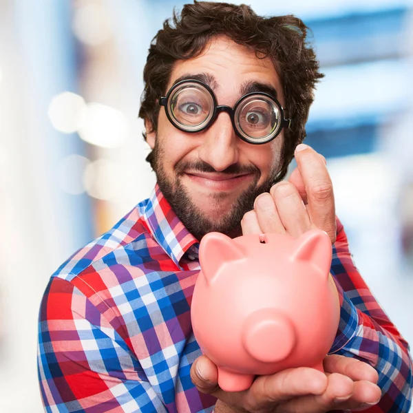 Crazy man with a piggy bank — Stock Photo, Image