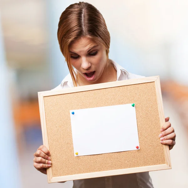 Blond woman with cork board — Stock Photo, Image