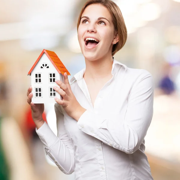 Blond woman with a small house — Stock Photo, Image