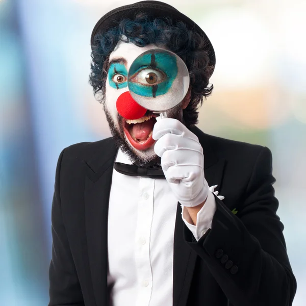 Clown with a magnifier glass — Stock Photo, Image