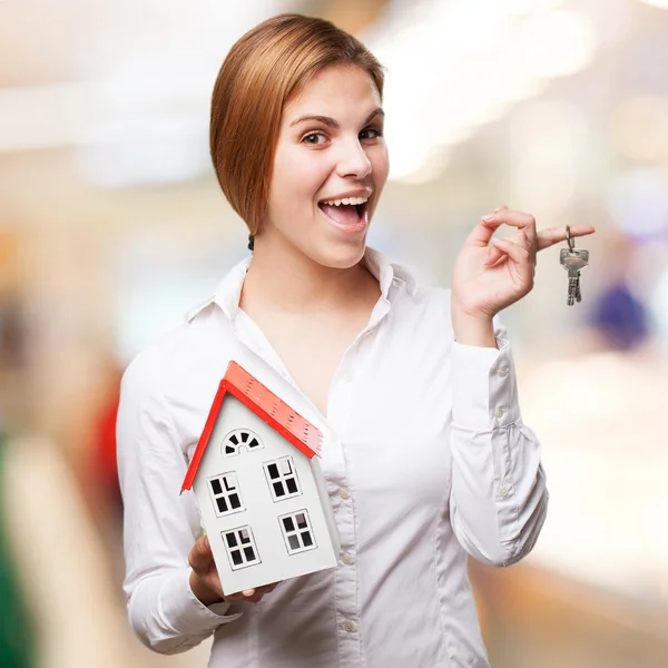 Mujer rubia con una pequeña casa y llaves — Foto de Stock