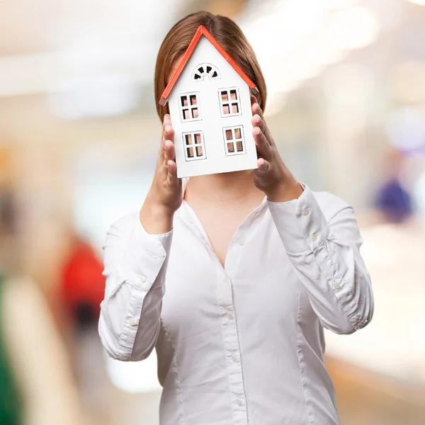 Blond woman with a small house — Stock Photo, Image