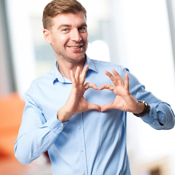 Blond man heart sign — стоковое фото