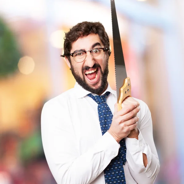 Businessman with a saw — Stock Photo, Image