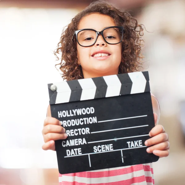 Black girl with a clapperboard — Stock Photo, Image