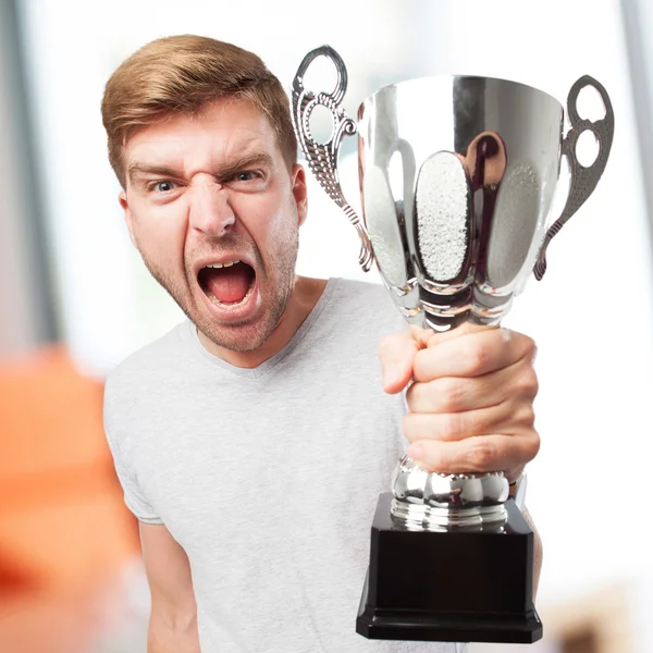 Blond winner man with a cup Stock Photo