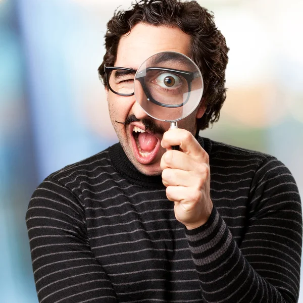 Pedantic man with a magnifier surprised Royalty Free Stock Photos