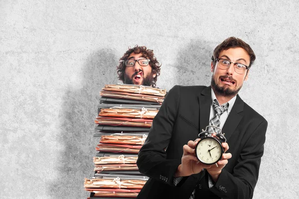 Young crazy businessman with an alarm clock — Stock Photo, Image