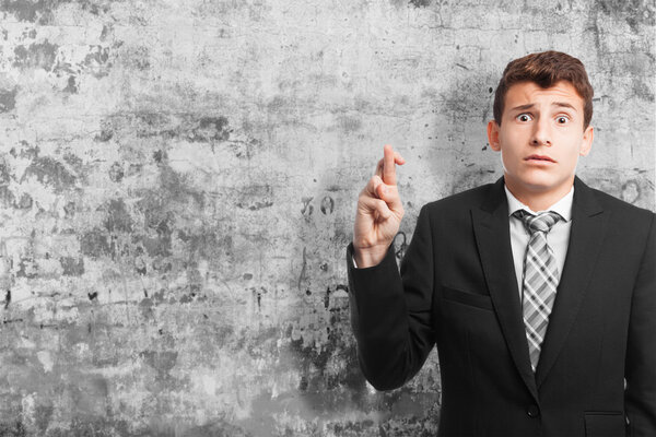 businessman finger crossing