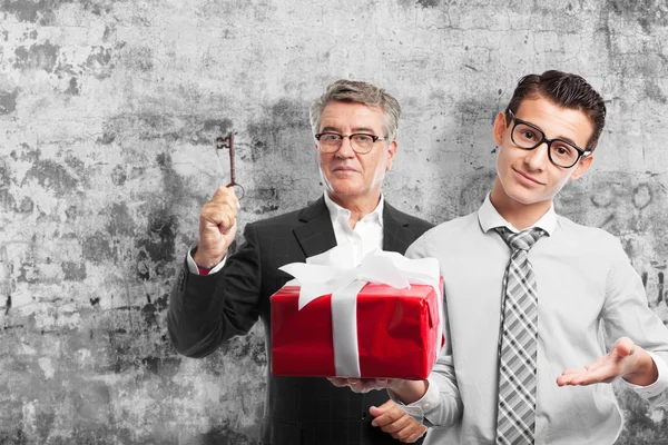 Businessman with a gift — Stock Photo, Image