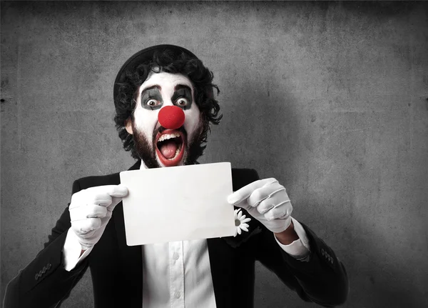 Clown met een spandoek — Stockfoto