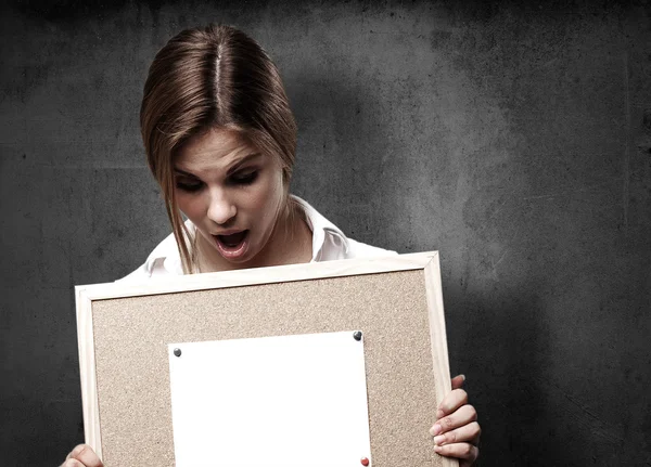 Blond woman with cork board — Stock Photo, Image