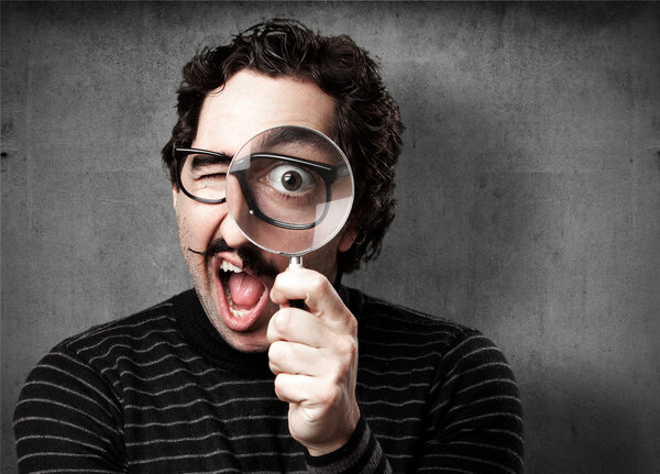 pedantic man with a magnifier surprised