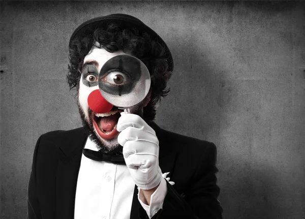 Clown with a magnifier glass — Stock Photo, Image