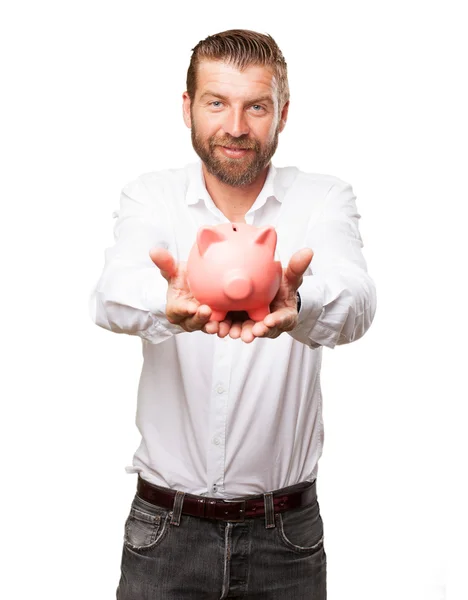 Glücklicher junger Mann mit Sparschwein — Stockfoto