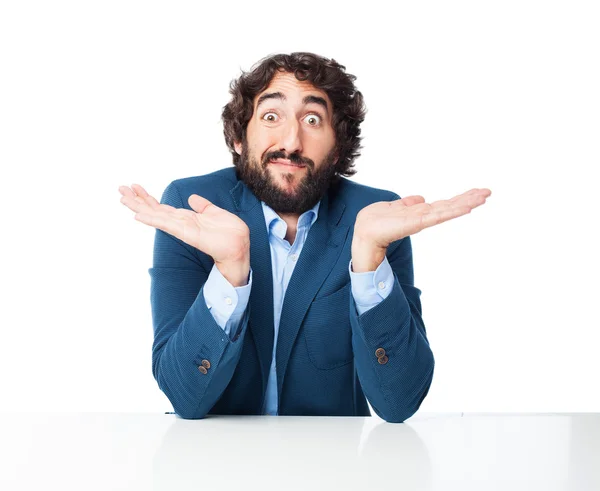 Confused businessman with sit table — Stock Photo, Image