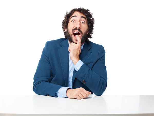 Confused businessman with sit table — Stock Photo, Image