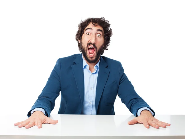 Scared businessman with sit table — Stock Photo, Image