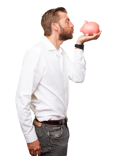 Happy young man with piggy bank — Stock Photo, Image