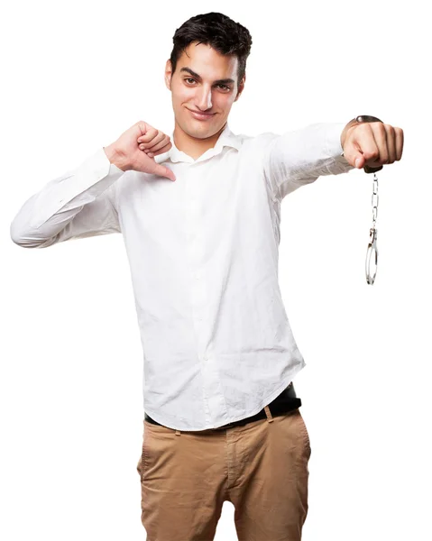 Happy young man with handcuffs — Stock Photo, Image