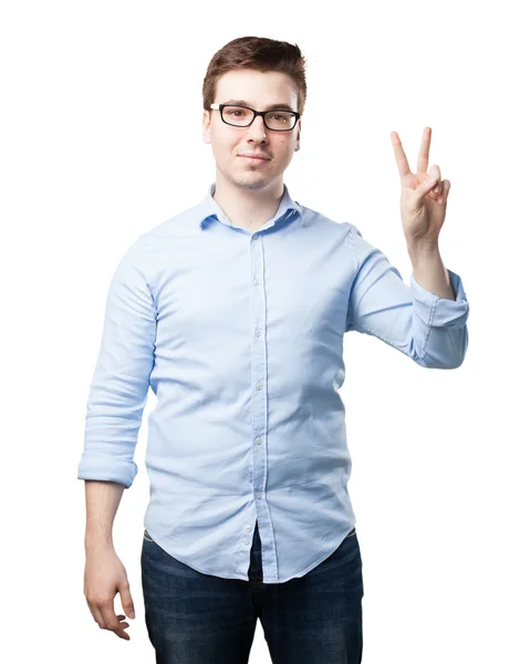 Happy young man with victory sign — Stock Photo, Image