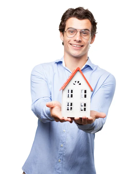 Happy young man with house model — Stock Photo, Image