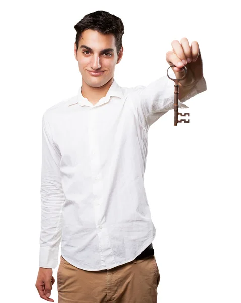 Proud young man with vintage key — Stock Photo, Image