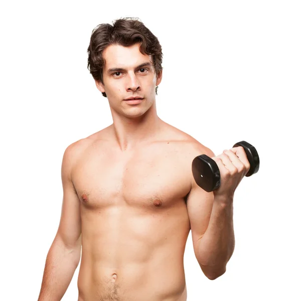 Strong young man with dumbbell — Stock Photo, Image