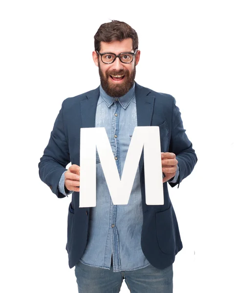 Happy businessman holding letter M — Stock Photo, Image