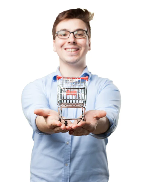 Felice giovane uomo con carrello della spesa — Foto Stock