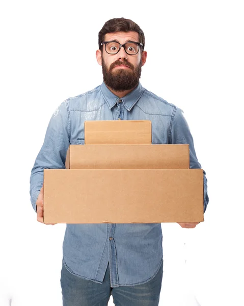 Stressed young man with boxes — Stock Photo, Image