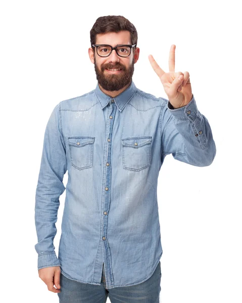 Happy young man with victory sign — Stock Photo, Image