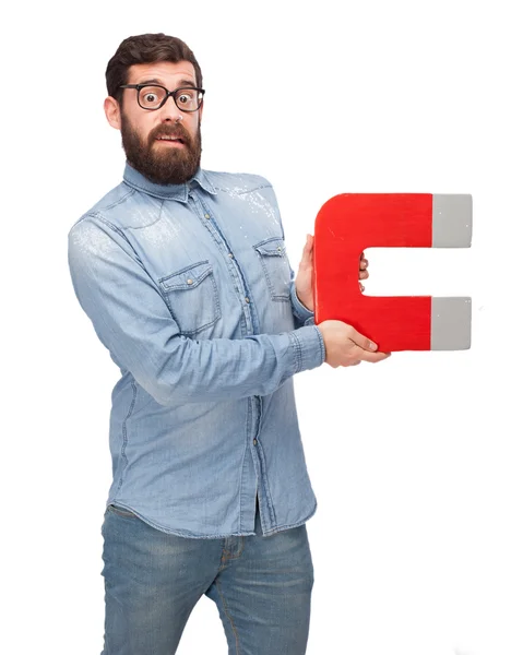 Worried young man with magnet — Stock Photo, Image