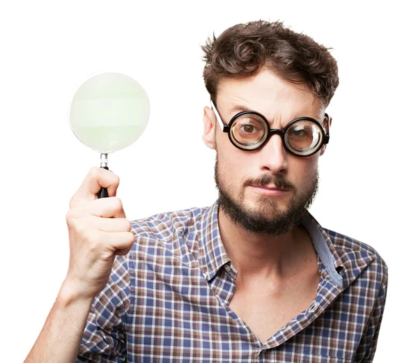 Crazy young man with magnifying glass — Stock Photo, Image