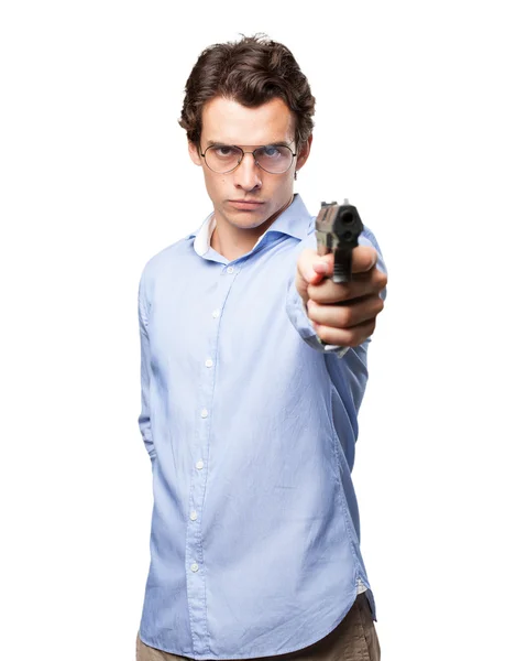 Angry young man with gun — Stock Photo, Image