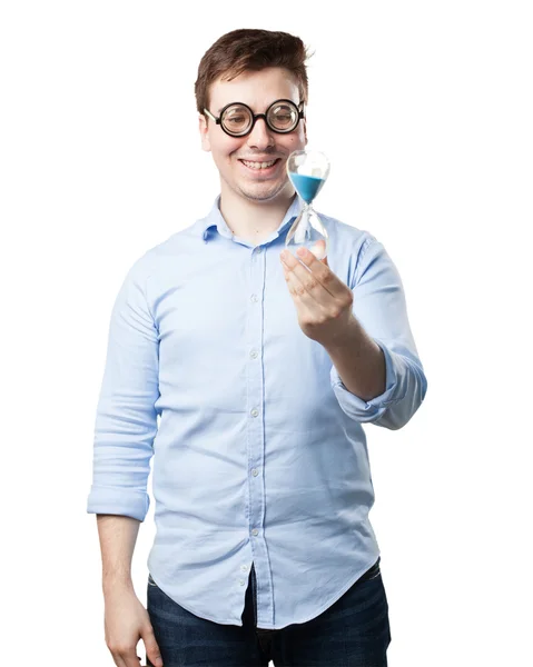 Crazy young man with sand timer — Stock Photo, Image