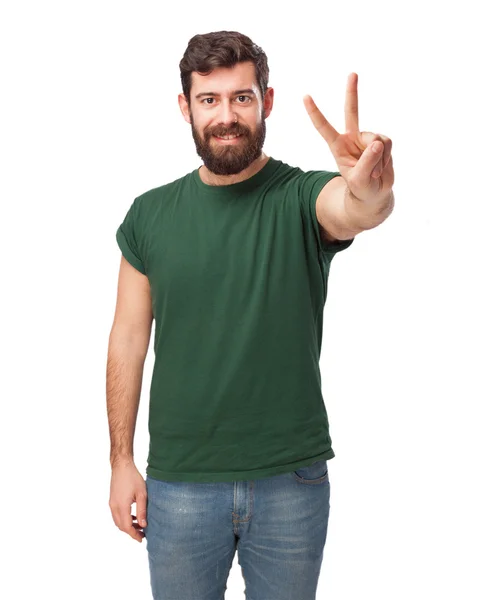 Happy young man with victory sign — Stock Photo, Image