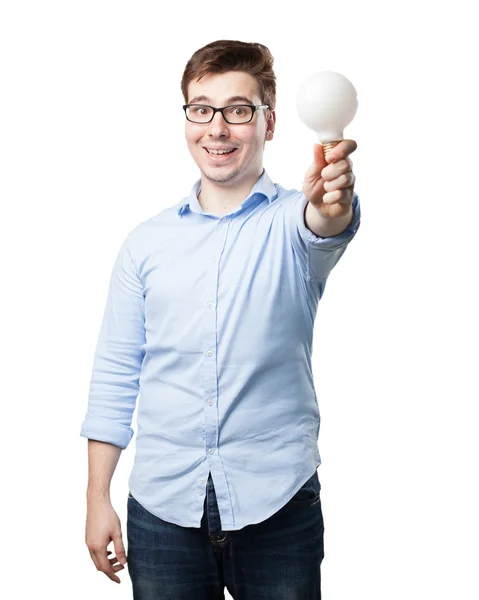 Happy young man with bulb — Stock Photo, Image