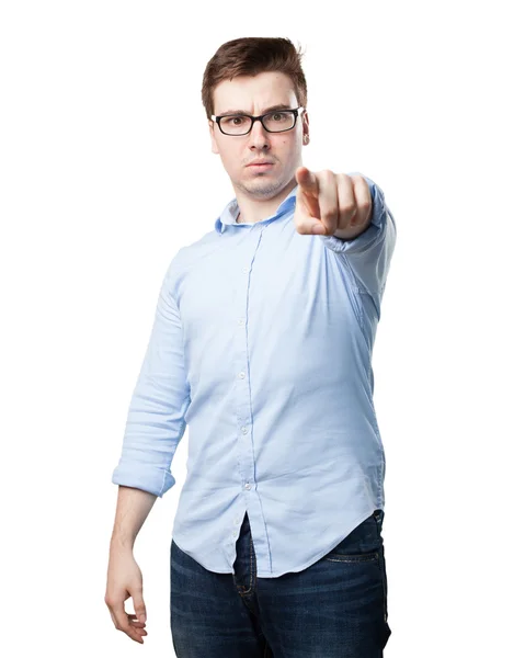 Angry young man pointing front — Stock Photo, Image