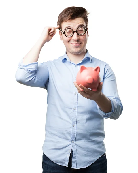 Crazy young man with piggy bank — Stock Photo, Image