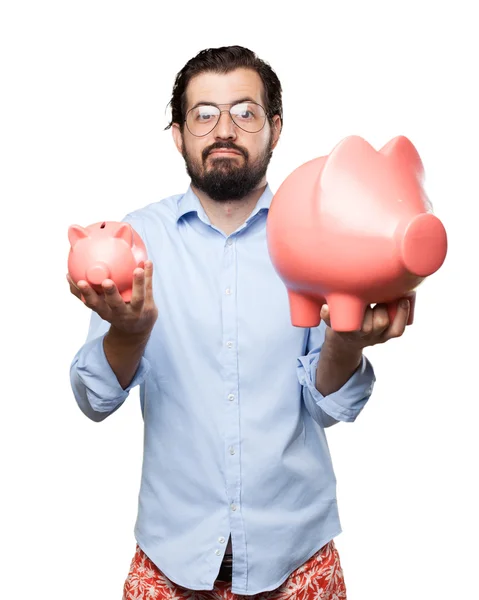 Verward jongeman met piggy bank — Stockfoto