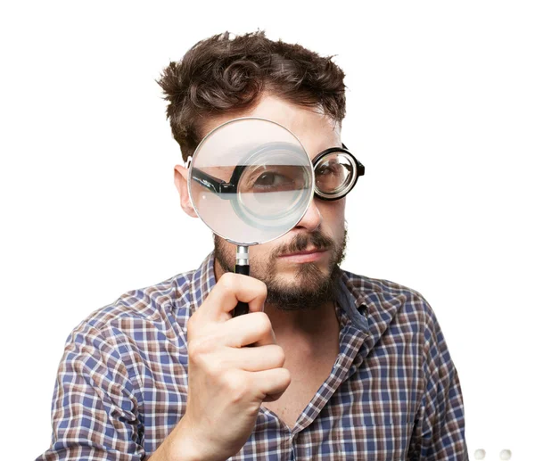 Crazy young man with magnifying glass — Stock Photo, Image
