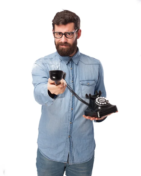 Angry young man with telephone — Stock Photo, Image