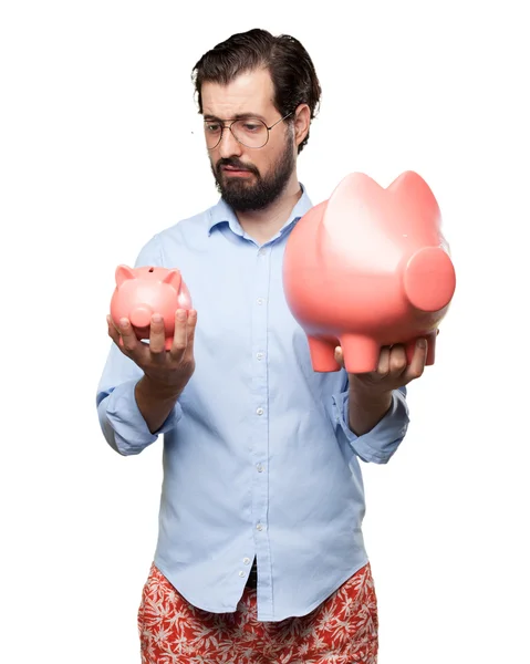 Sad young man with piggy bank — Stock Photo, Image