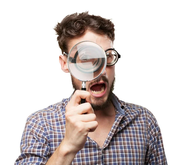 Crazy young man with magnifying glass — Stock Photo, Image